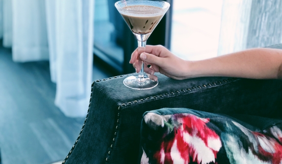 closeup shot of a hand holding a chocolate martini